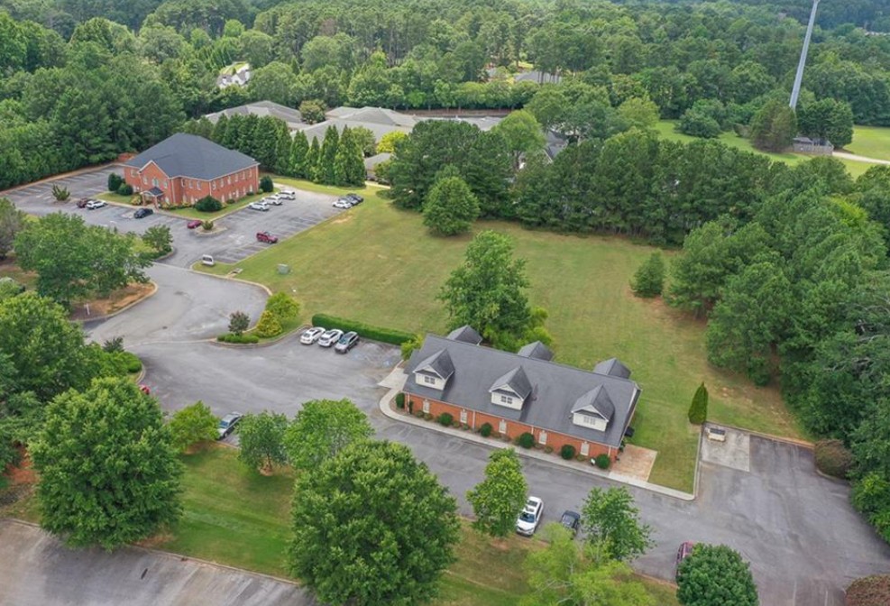 120 Perpetual Square Drive Anderson, SC 29621 - Photo 4 of 14 An aerial perspective reveals two distinct brick structures nestled among verdant trees and ample parking areas.