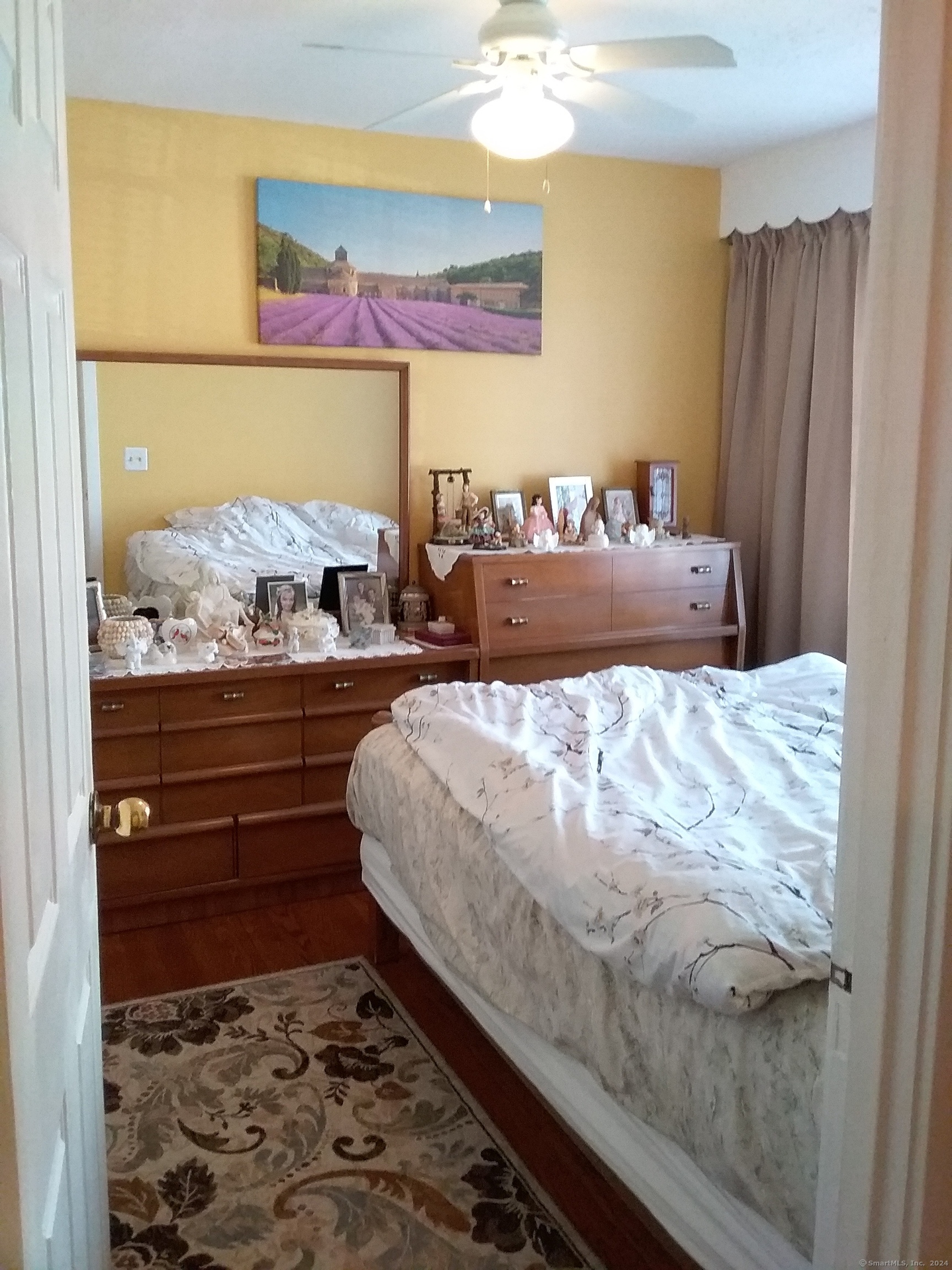 440 Success Avenue, Unit BLDG86 18 Bridgeport, CT 06610 - Photo 7 of 8 a bed sitting in a bedroom and painting on the wall