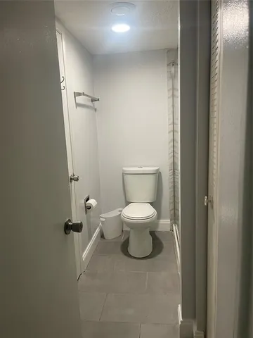 a white toilet sitting next to a bathroom sink
