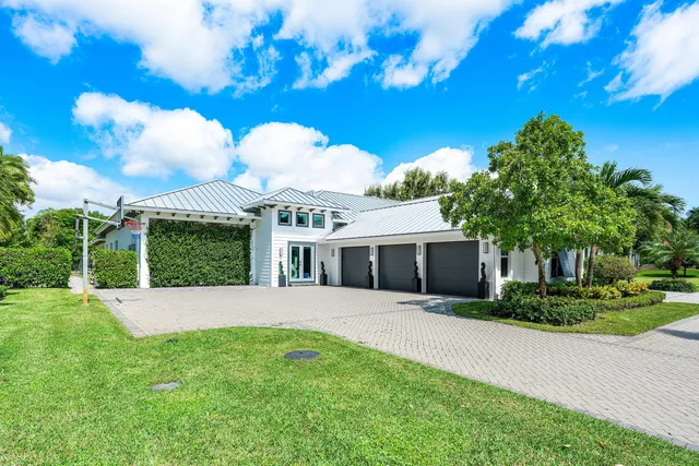 a front view of a house with yard and green space