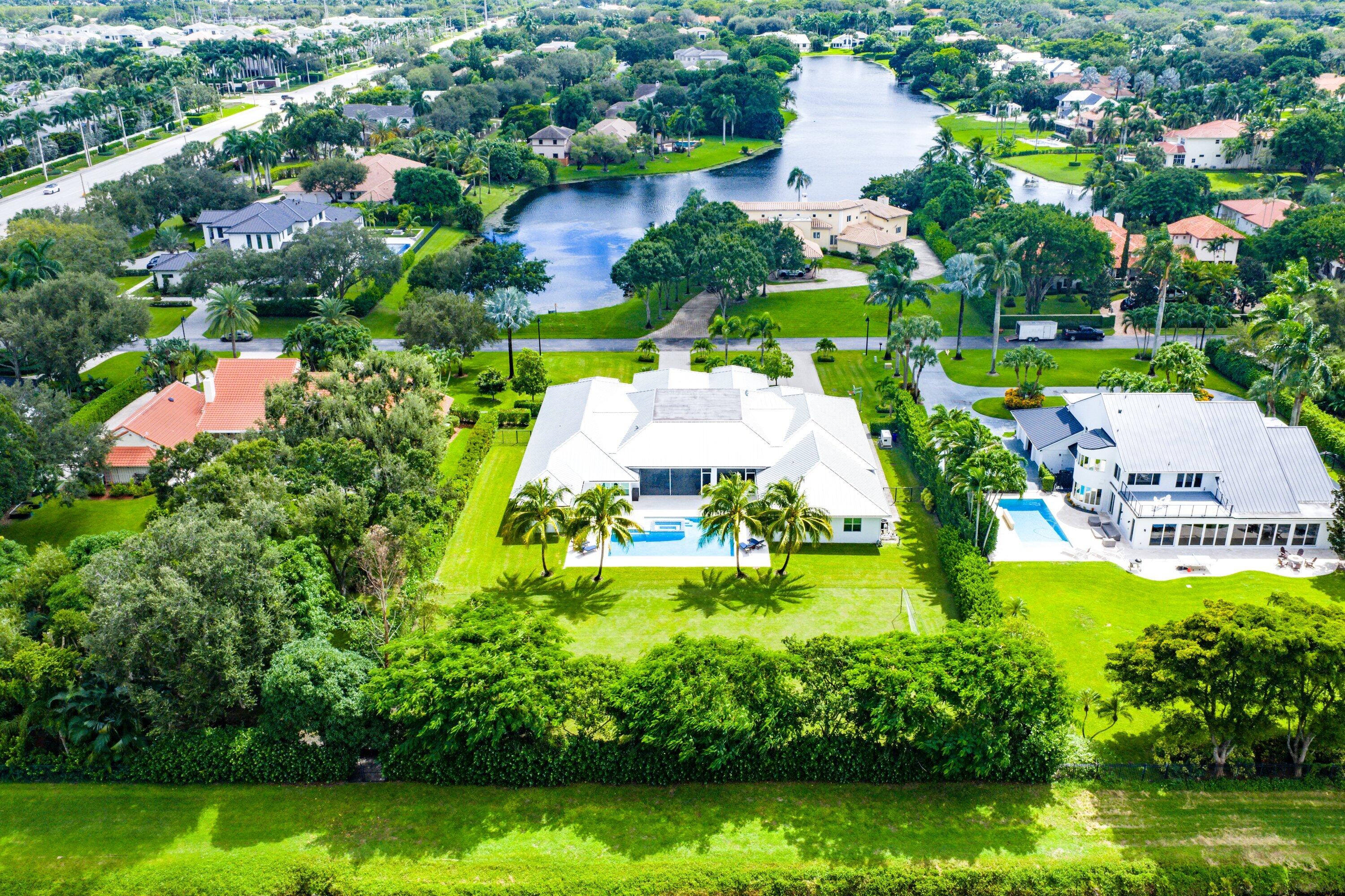 17664 Fieldbrook Circle East Boca Raton, FL 33496 - Photo 84 of 90 an aerial view of a house with swimming pool a yard and lake view