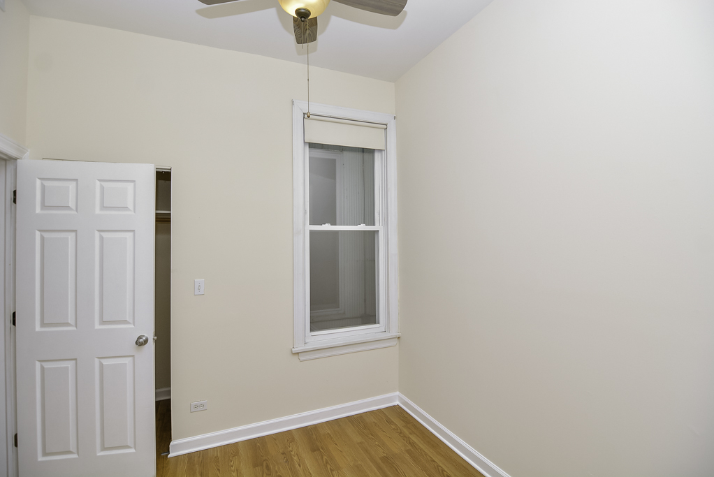 2145 West Chicago Avenue, Unit 2 Chicago, IL 60622 - Photo 11 of 19 a view of an empty room with wooden floor and a window