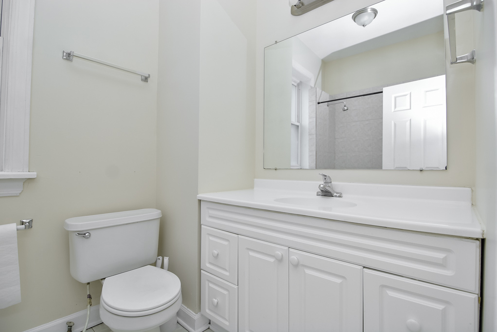 2145 West Chicago Avenue, Unit 2 Chicago, IL 60622 - Photo 14 of 19 a bathroom with a sink a toilet and a mirror
