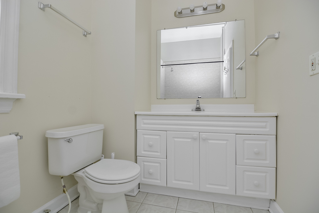 2145 West Chicago Avenue, Unit 2 Chicago, IL 60622 - Photo 16 of 19 a bathroom with a toilet sink and mirror