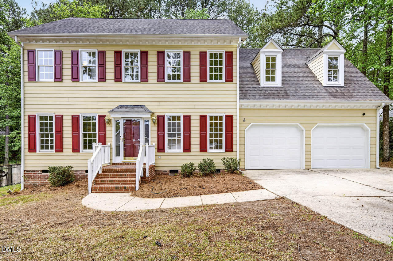2209 Lodestar Drive Raleigh, NC 27615 - Photo 1 of 50 a front view of a house with a yard and garage