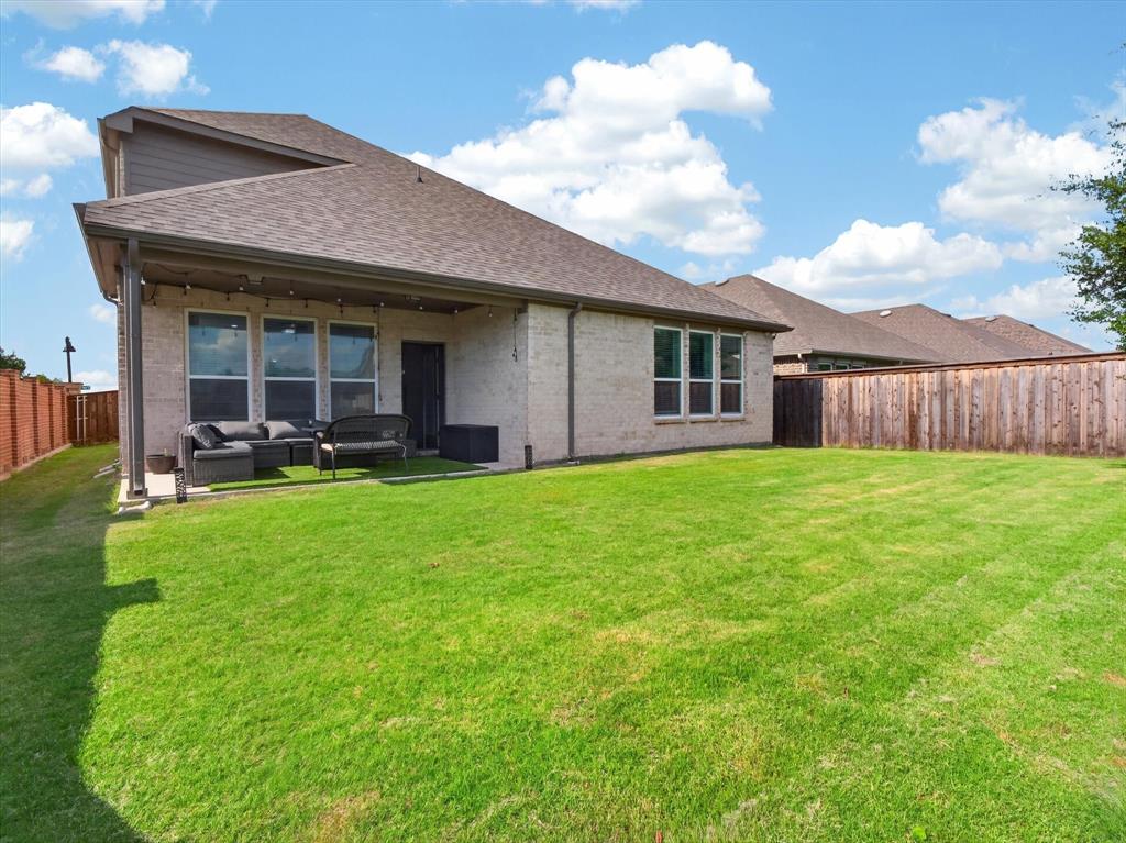 636 Corner Post Path Celina, TX 75009 - Photo 34 of 40 Expansive backyard featuring a lush lawn, a covered patio, and a privacy fence