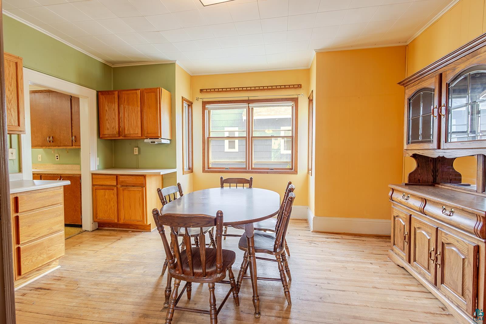 438 9th Street Cloquet, MN 55720 - Photo 10 of 27 Dining area featuring wood-finish flooring and ample natural light through multiple windows