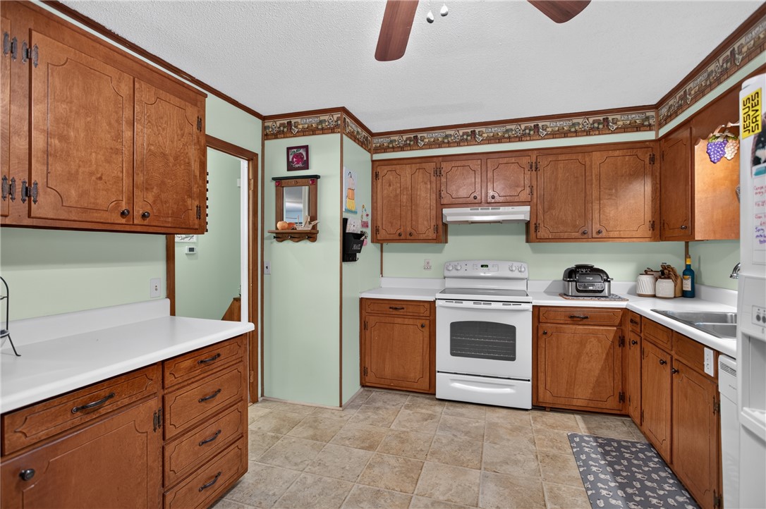 104 Laurel Lane Seneca, SC 29678 - Photo 8 of 36 Functional kitchen with ample cabinetry and resilient tile flooring, ready for culinary endeavors.