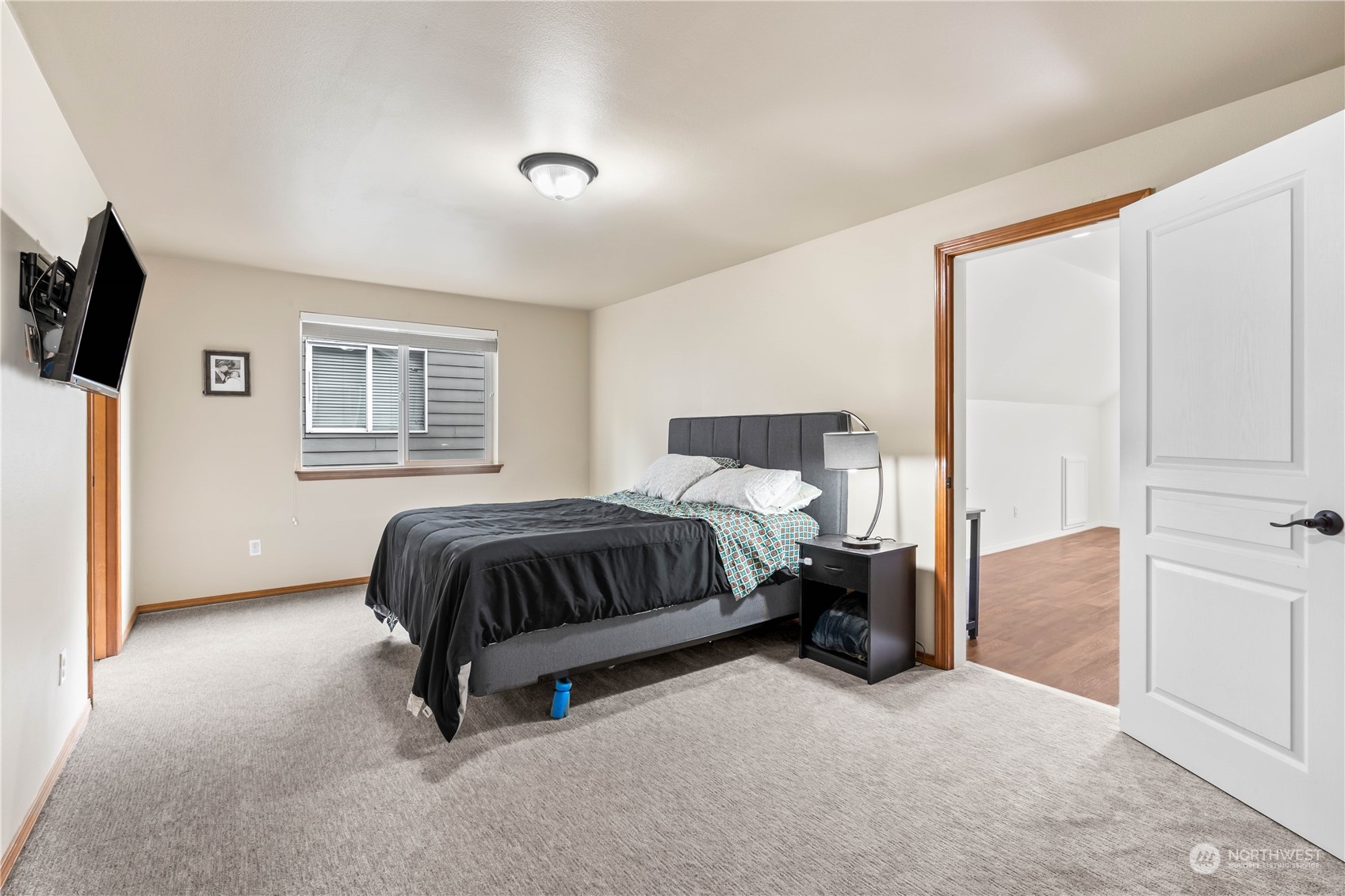 8226 Racca Court Southeast Olympia, WA 98513 - Photo 18 of 40 a spacious bedroom with a bed and flat screen tv