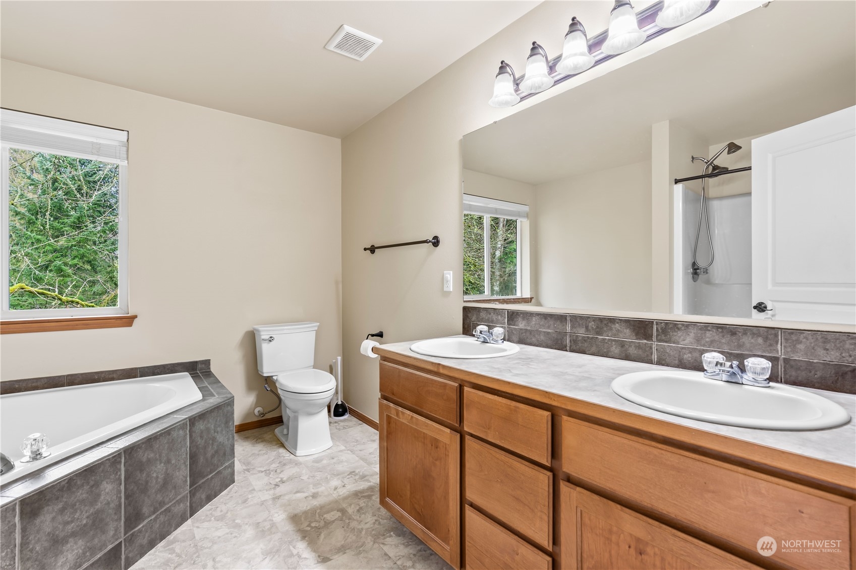 8226 Racca Court Southeast Olympia, WA 98513 - Photo 20 of 40 a bathroom with a granite countertop sink mirror and a bathtub