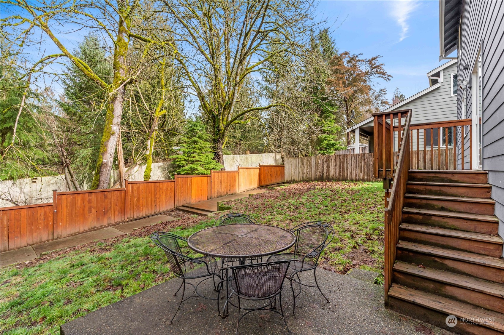 8226 Racca Court Southeast Olympia, WA 98513 - Photo 31 of 40 a view of backyard with table and chairs and wooden fence