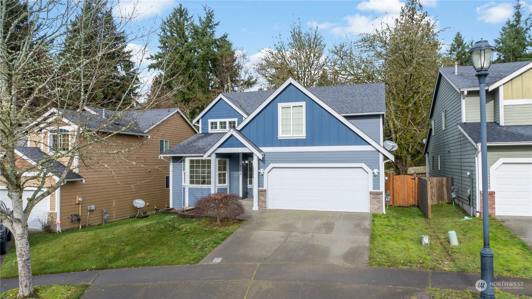 8226 Racca Court Southeast Olympia, WA 98513 - Photo 6 of 40 a front view of a house with a yard and garage