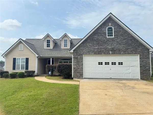 a front view of a house with yard and garage