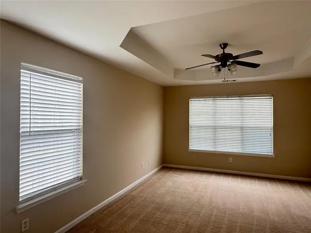 a view of a livingroom with a window and a ceiling fan