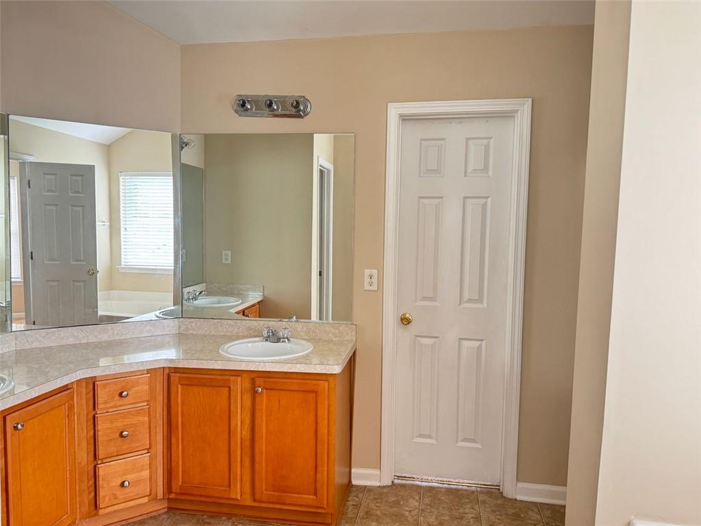 5432 Village Ridge Fairburn, GA 30213 - Photo 12 of 18 a bathroom with a granite countertop sink and a mirror