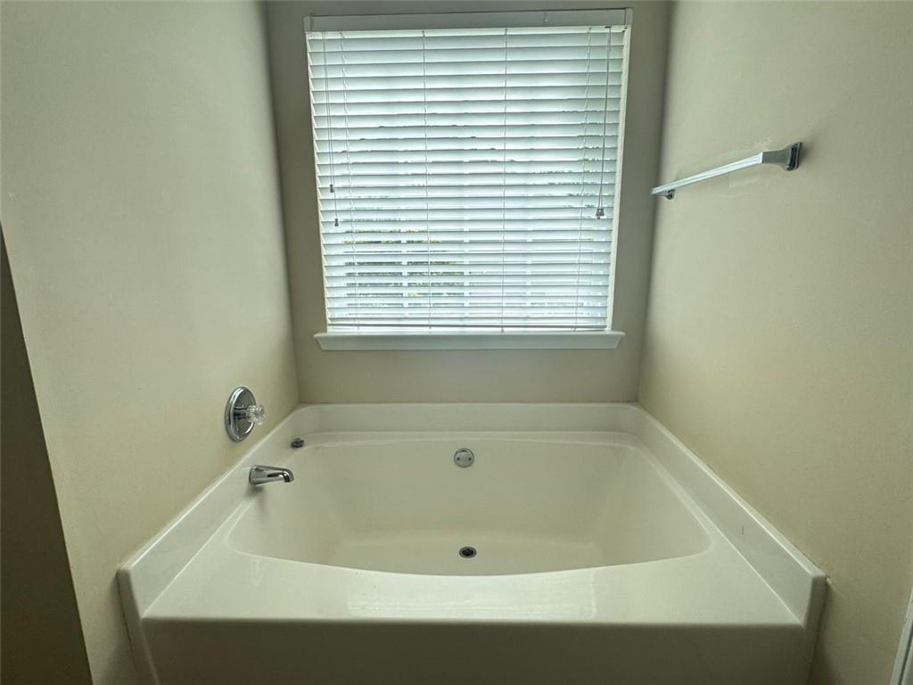 5432 Village Ridge Fairburn, GA 30213 - Photo 14 of 18 a bath tub sitting in a bathroom next to a window