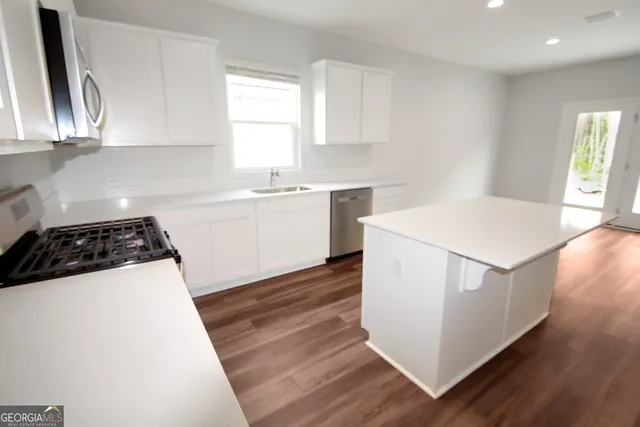 a kitchen with a white stove top oven and sink