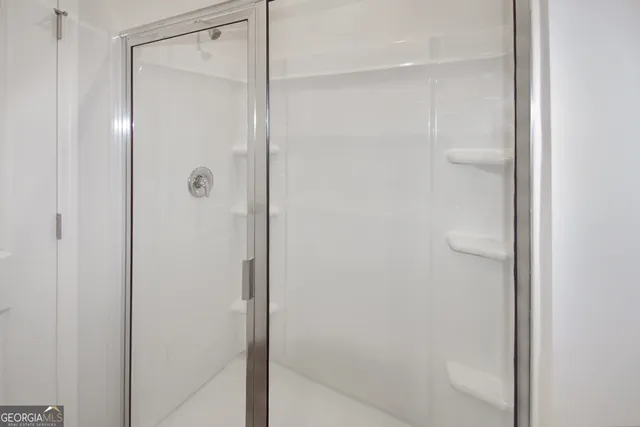 a bathroom with a glass shower door
