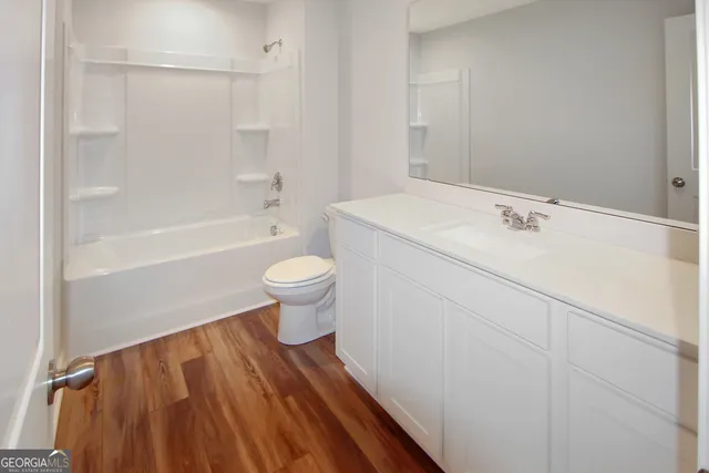 a view of bathroom with a bathtub and toilet