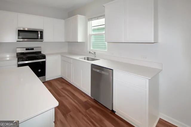 a kitchen with a sink and a stove top oven
