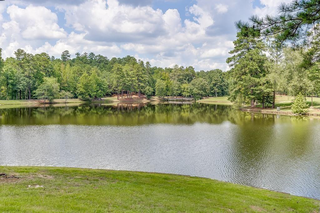 5775 Kennedy Road Suwanee, GA 30024 - Photo 8 of 23 a view of a lake with houses in the back