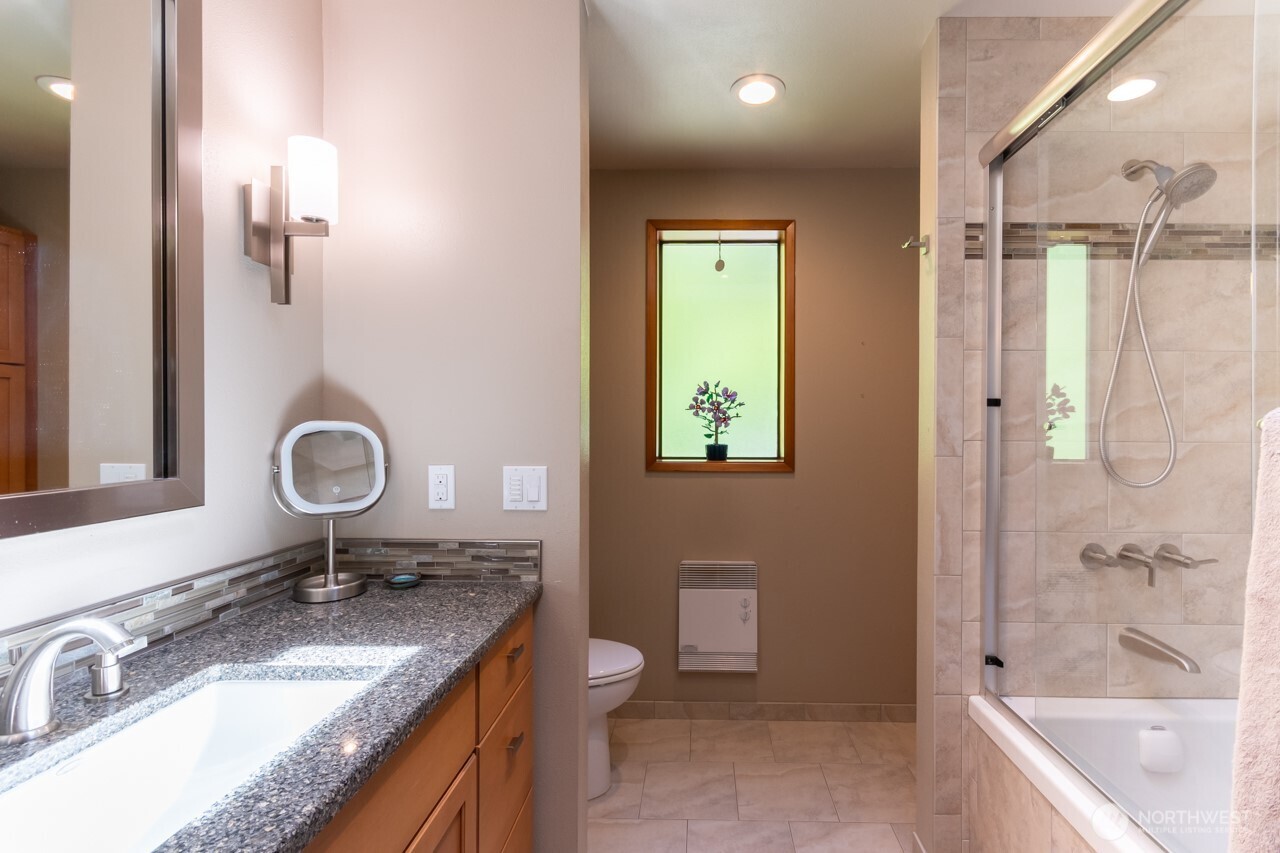 492 Walkabout Way Port Angeles, WA 98363 - Photo 23 of 40 a bathroom with a granite countertop sink a toilet and shower
