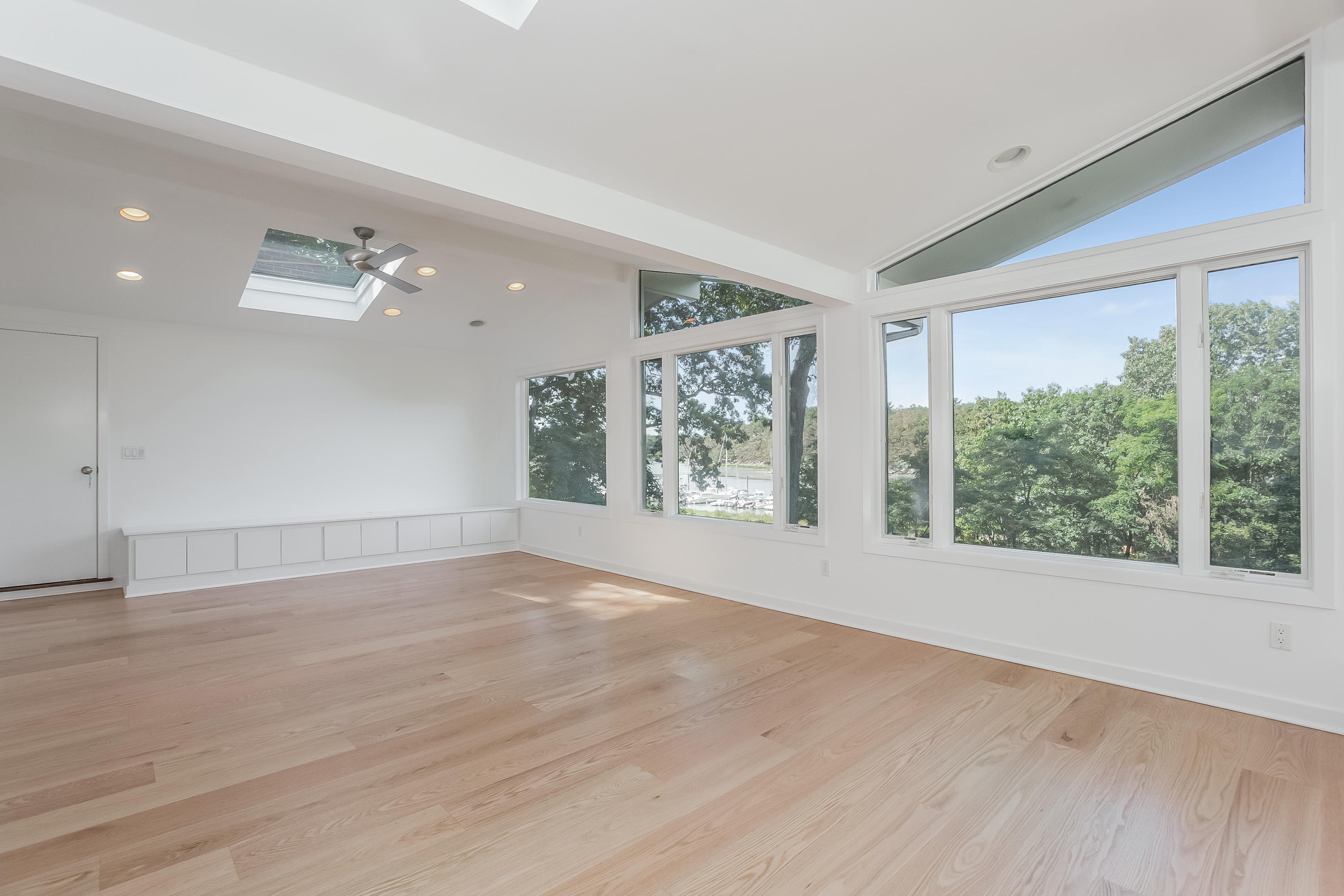 8 Outer Road Norwalk, CT 06854 - Photo 18 of 39 a view of an empty room with wooden floor and a window