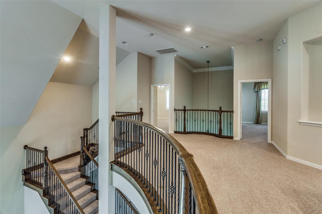 7504 Grace Avenue Plano, TX 75024 - Photo 16 of 36 a view of a hallway with wooden floor and stairs