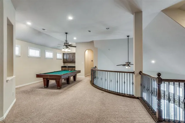 a view of a hallway with wooden floor and furniture