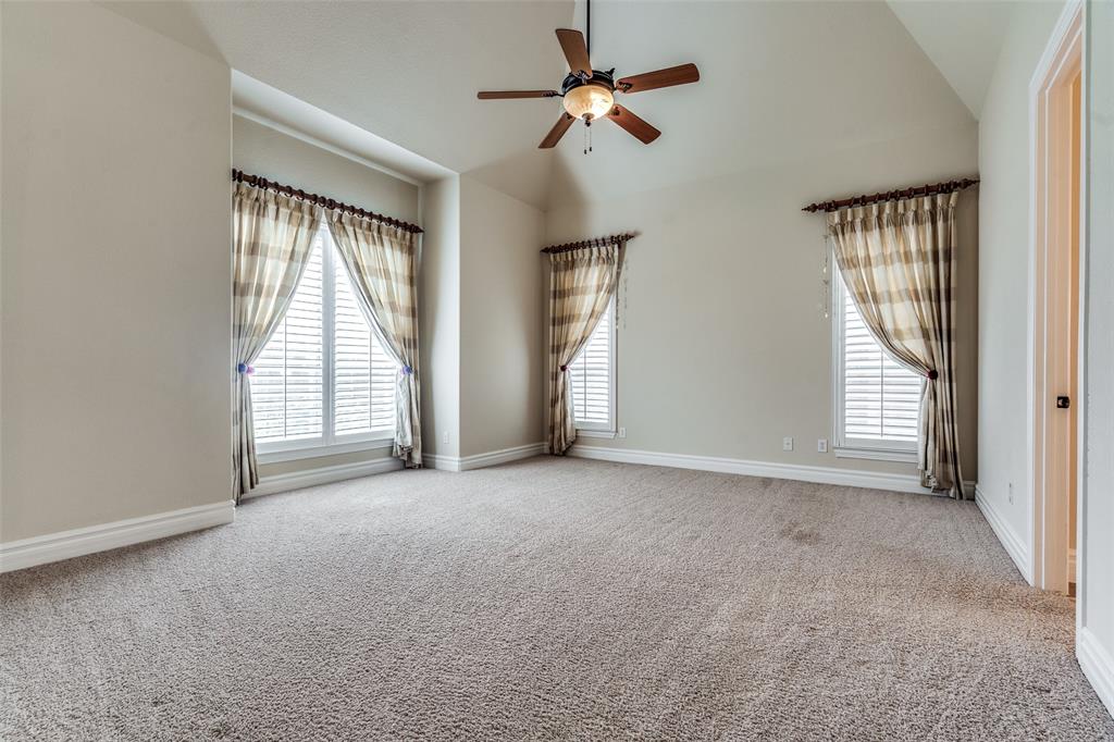 7504 Grace Avenue Plano, TX 75024 - Photo 22 of 36 an empty room with windows and fan