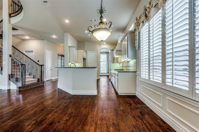 a view of a kitchen with wooden floor and a window