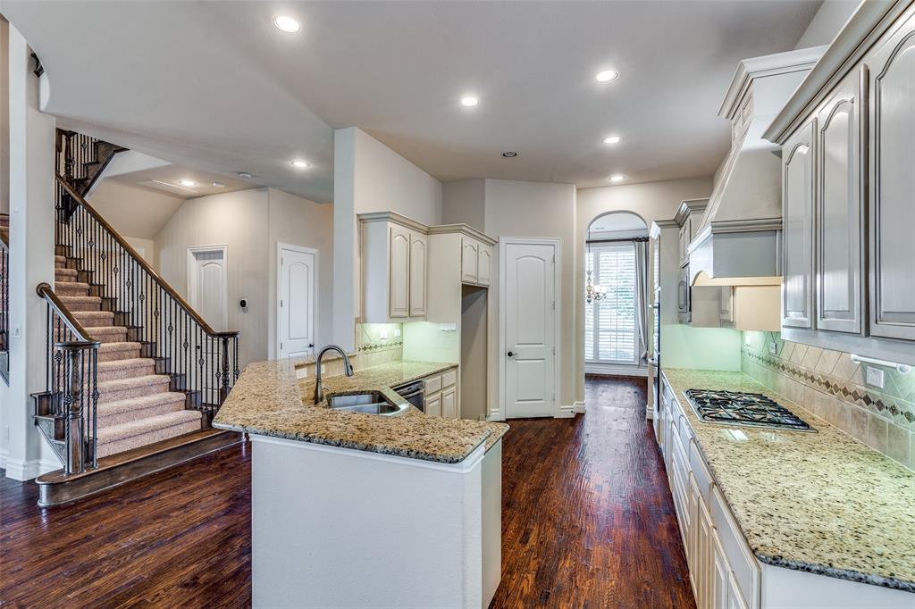 7504 Grace Avenue Plano, TX 75024 - Photo 10 of 36 a view of a kitchen with kitchen island granite countertop a large window a sink and a counter top space