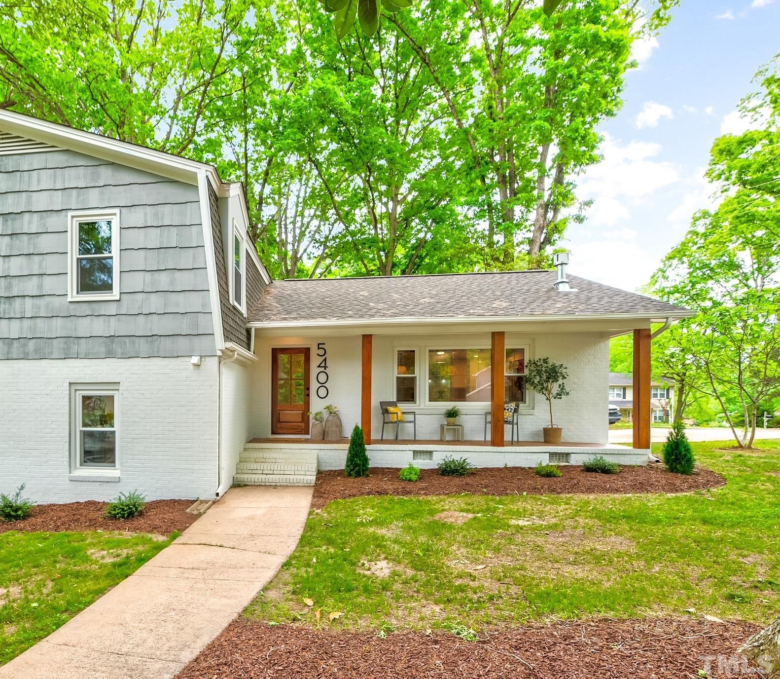 a view of a house with backyard and porch