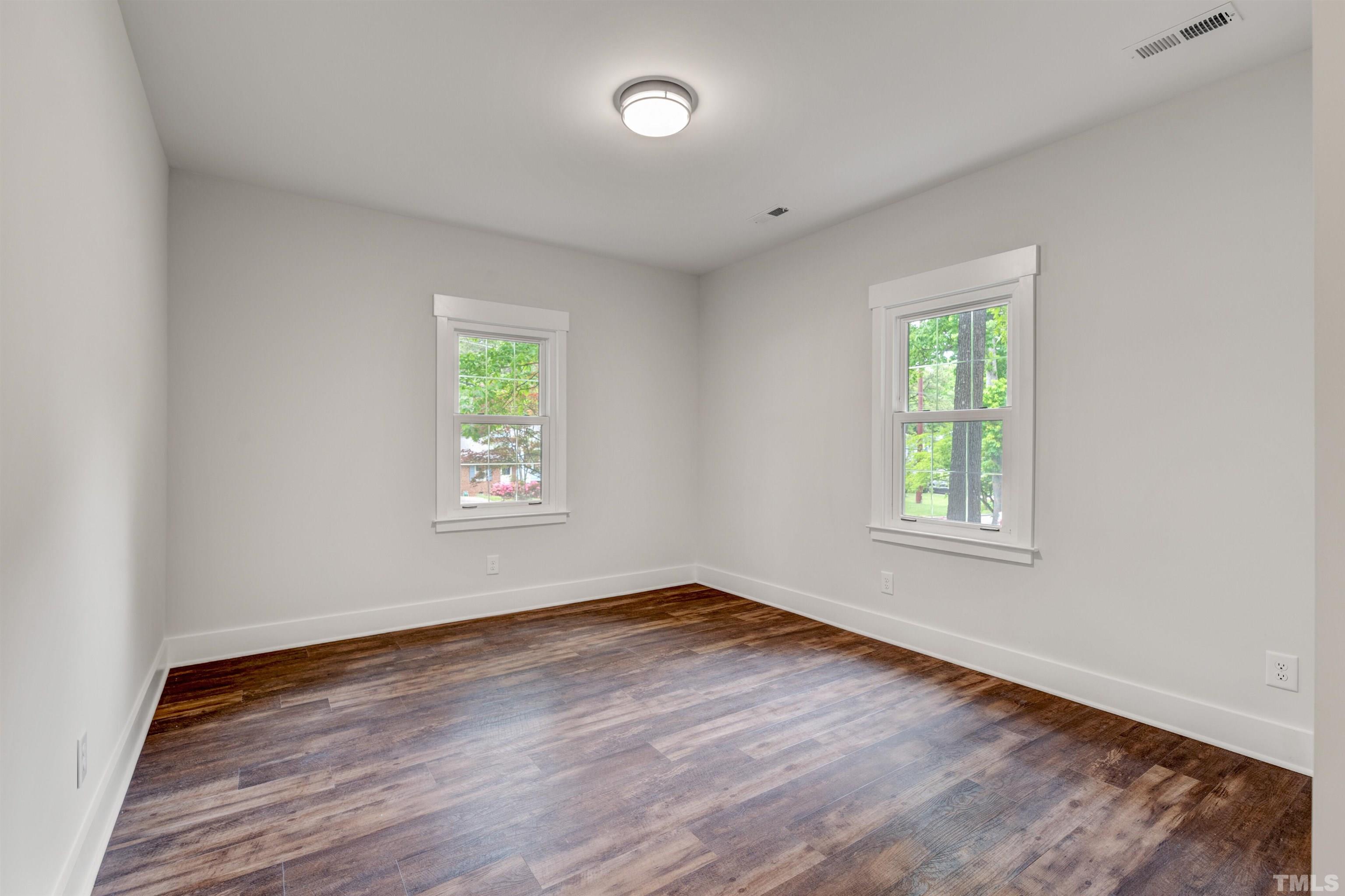 5400 Farley Drive Raleigh, NC 27609 - Photo 14 of 31 a view of an empty room with wooden floor and a window