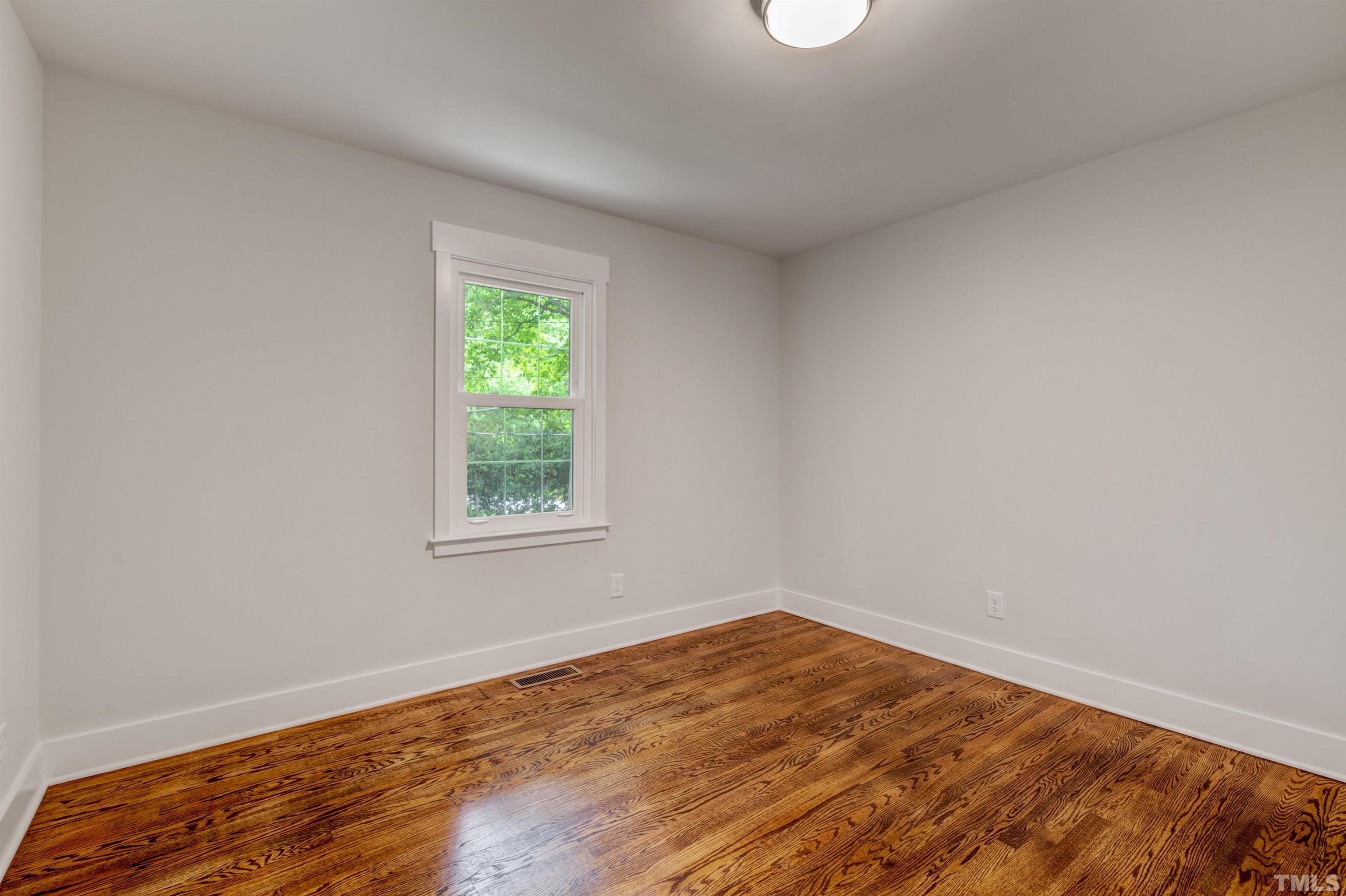 5400 Farley Drive Raleigh, NC 27609 - Photo 20 of 31 a view of empty room with wooden floor and fan
