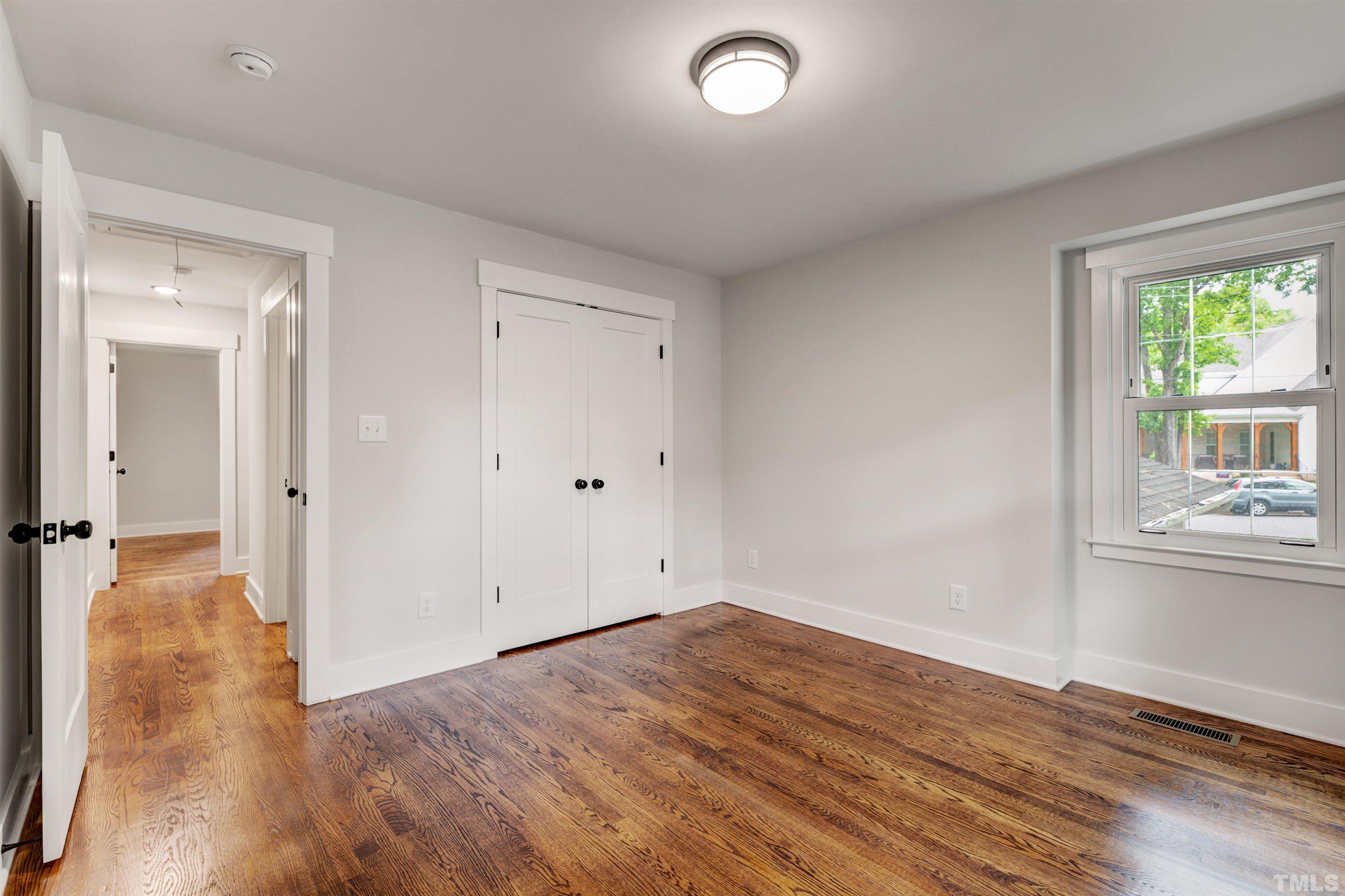 5400 Farley Drive Raleigh, NC 27609 - Photo 21 of 31 wooden floor in an empty room with a window