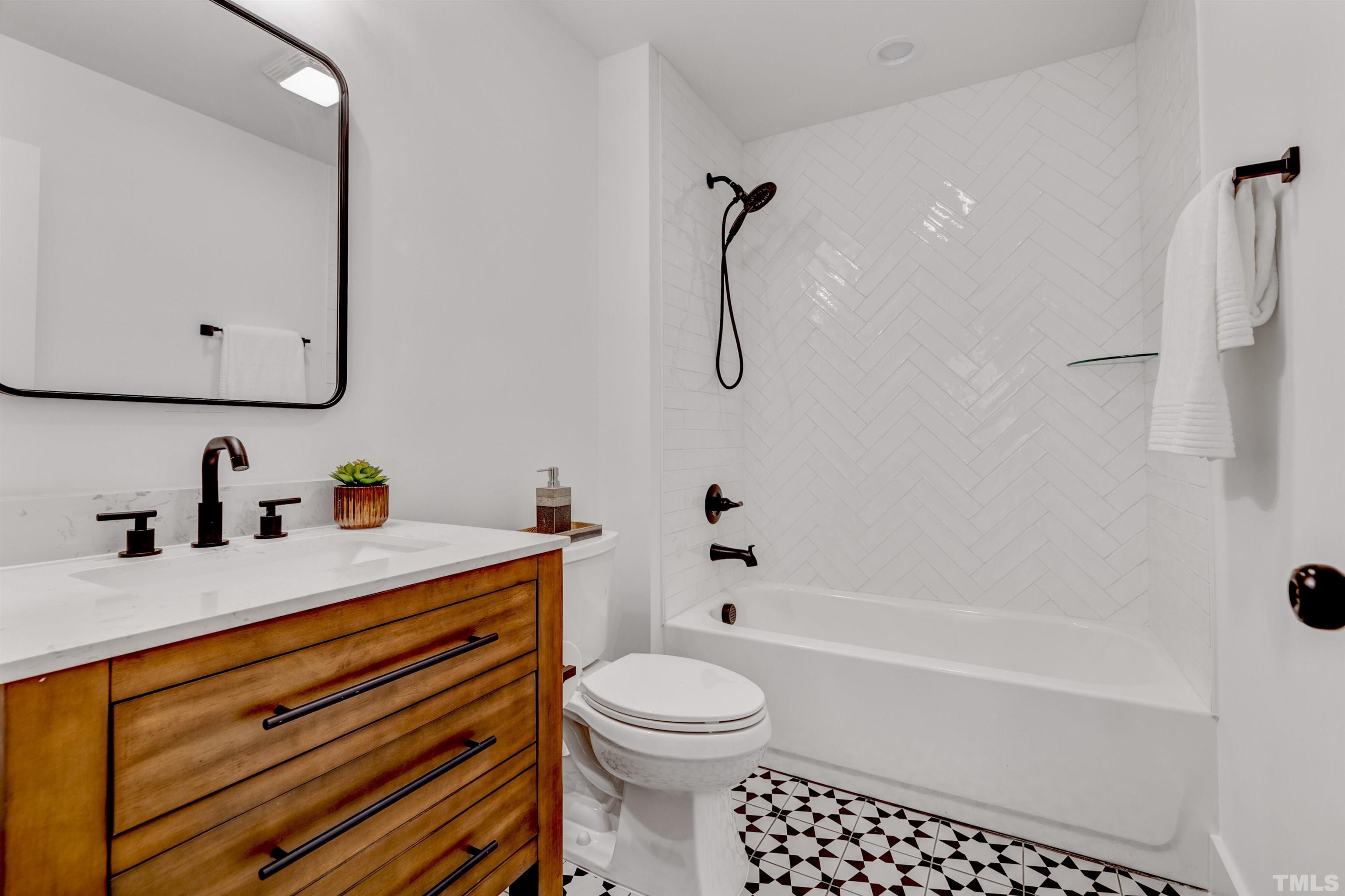 5400 Farley Drive Raleigh, NC 27609 - Photo 22 of 31 a bathroom with a sink a toilet and a bathtub