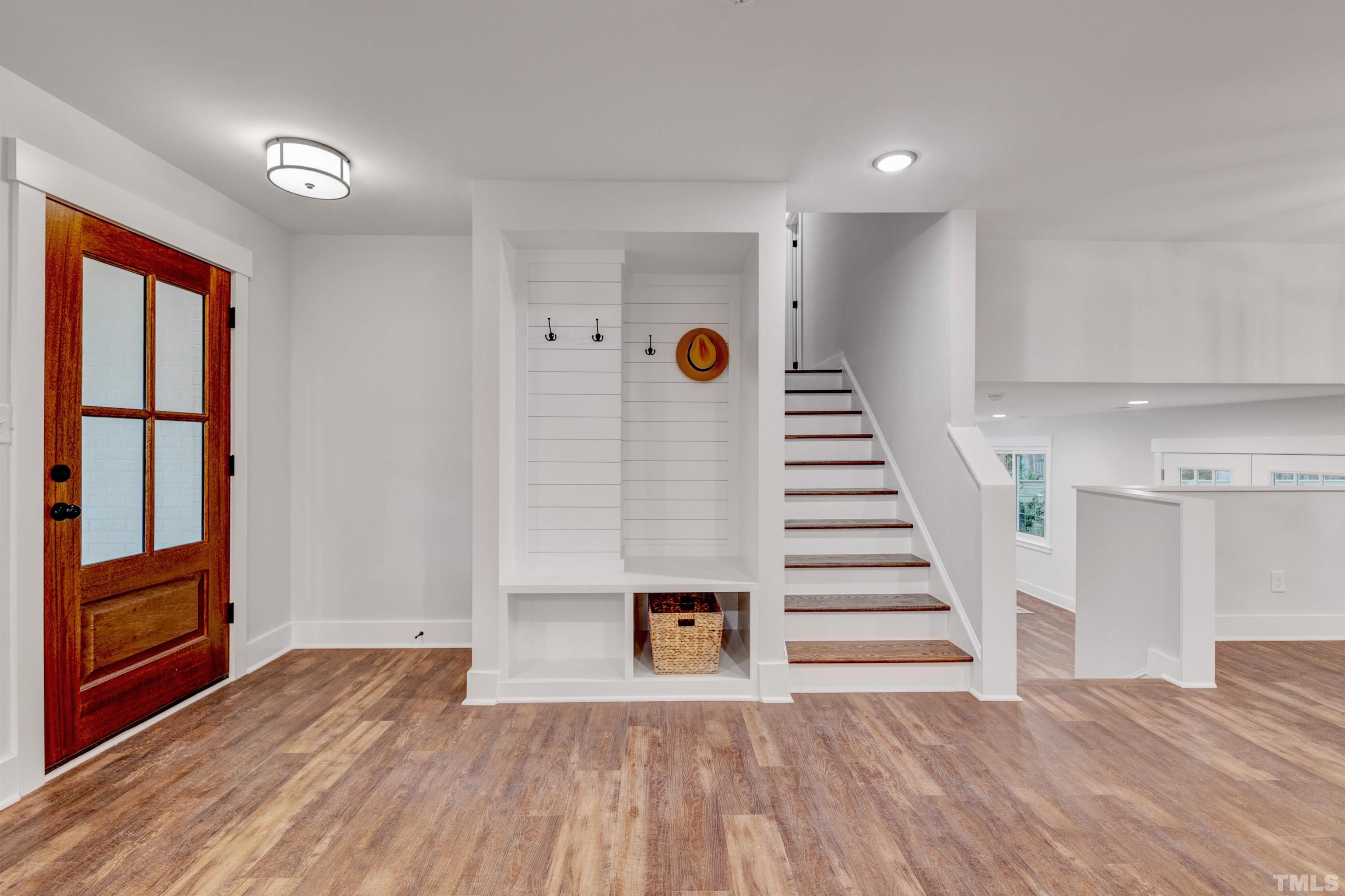 5400 Farley Drive Raleigh, NC 27609 - Photo 3 of 31 a view of a livingroom with wooden floor and stairs