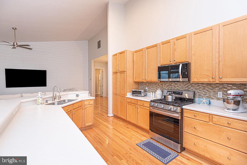 89 October Glory Avenue Ocean View, DE 19970 - Photo 25 of 77 a kitchen with stainless steel appliances a stove sink microwave and cabinets