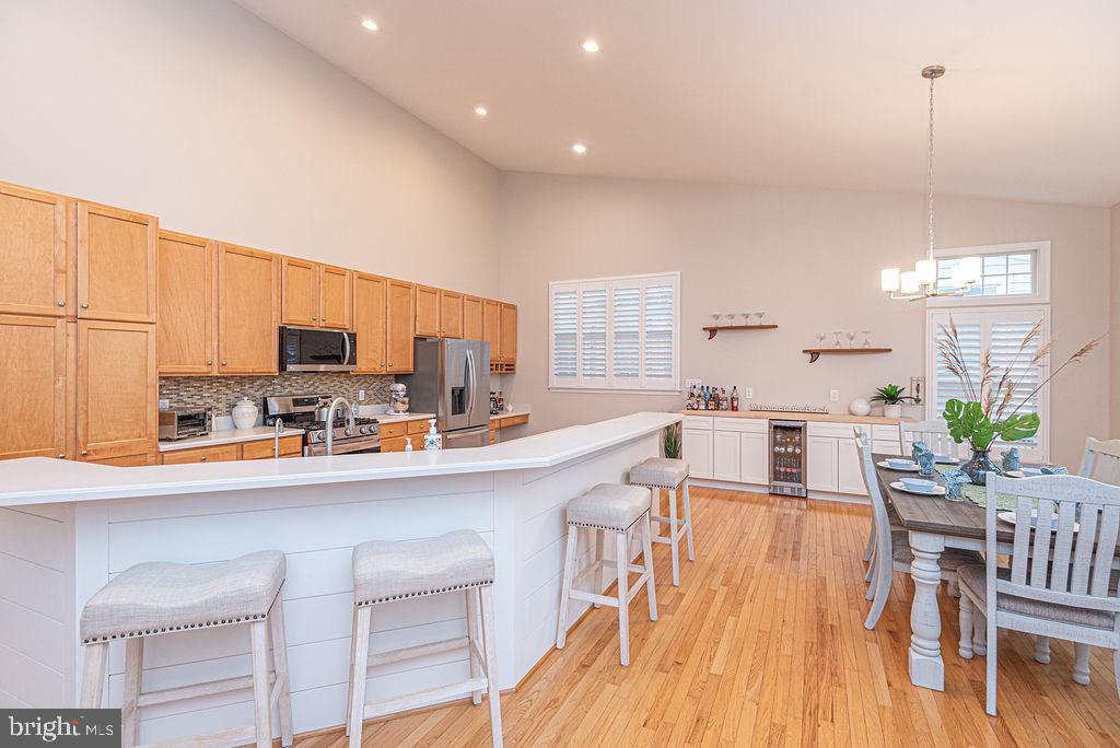 89 October Glory Avenue Ocean View, DE 19970 - Photo 34 of 77 a kitchen with stainless steel appliances a dining table chairs stove and cabinets