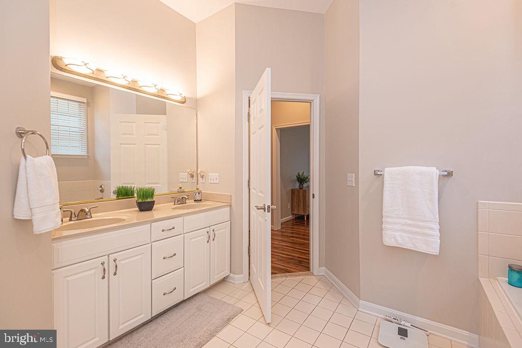 89 October Glory Avenue Ocean View, DE 19970 - Photo 44 of 77 a spacious bathroom with a double vanity sink a mirror and a shower