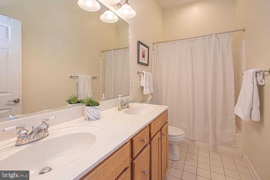 89 October Glory Avenue Ocean View, DE 19970 - Photo 49 of 77 a bathroom with a double vanity sink and a mirror