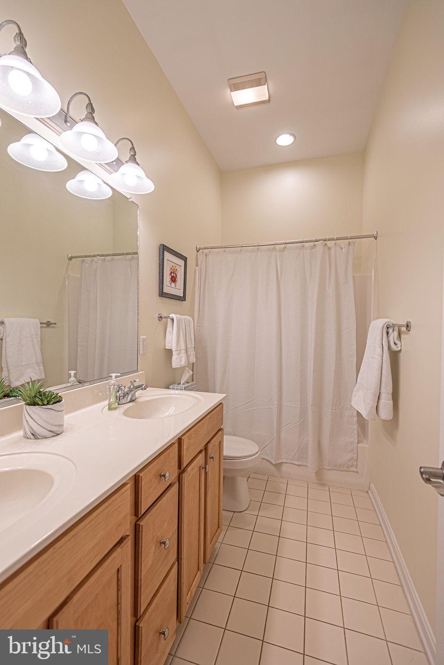 89 October Glory Avenue Ocean View, DE 19970 - Photo 50 of 77 a bathroom with a sink a toilet and a mirror