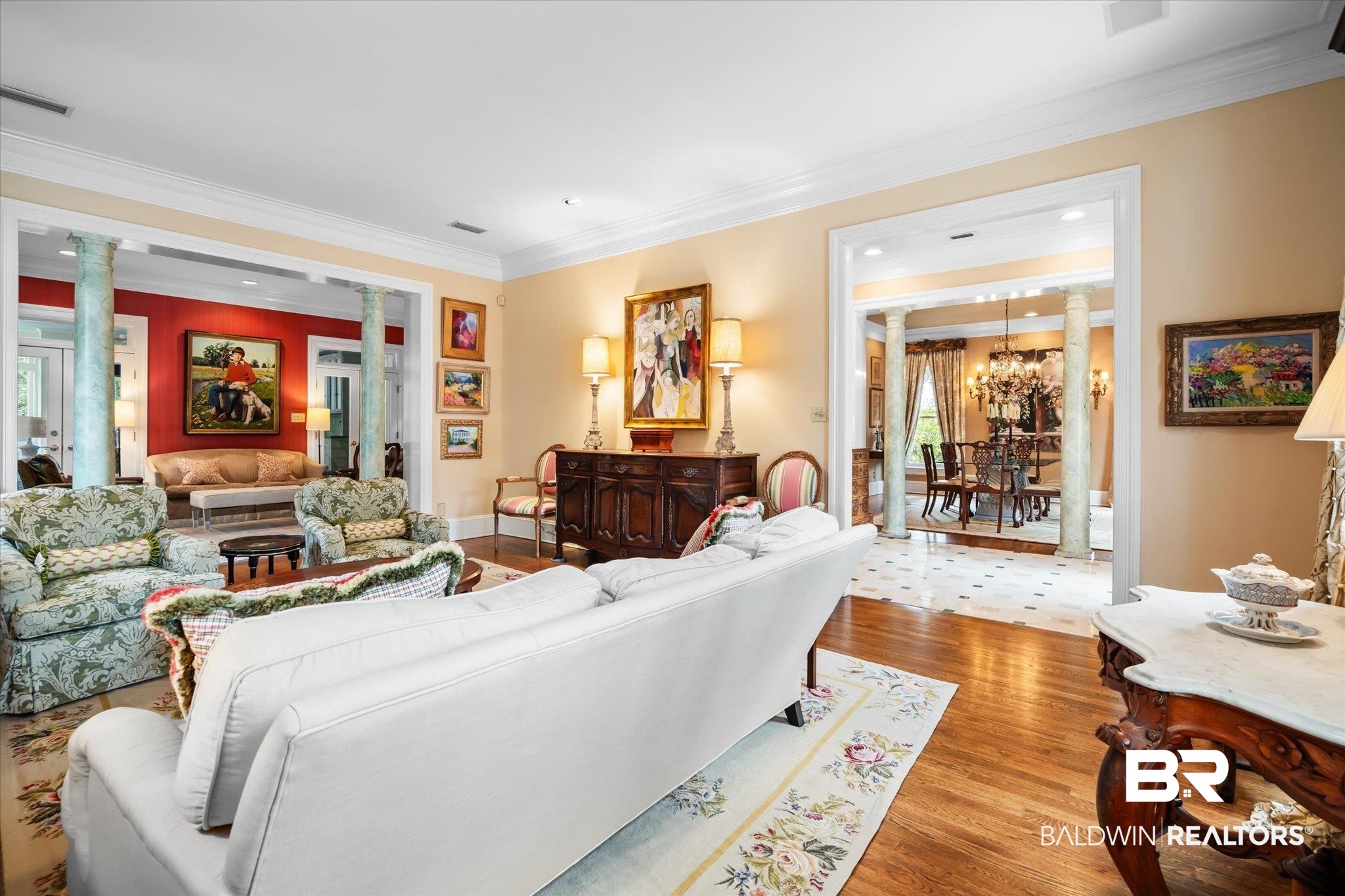 354 Dogwood Lane Mobile, AL 36608 - Photo 7 of 44 Living room with ornate columns, ornamental molding, light hardwood / wood-style flooring, and an inviting chandelier