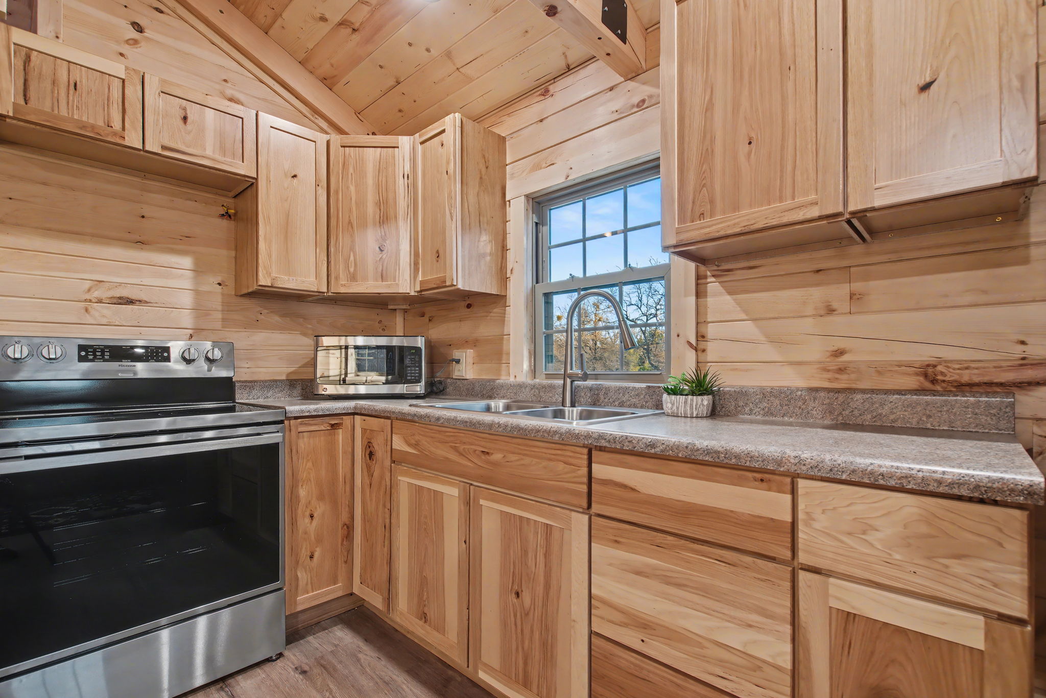 13510 County Road 3642 Kempner, TX 76539 - Photo 14 of 38 Kitchen featuring stainless steel appliances, wooden ceiling, light brown cabinetry, wood walls, and light wood-style flooring