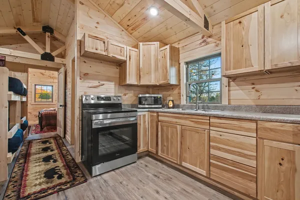 a living room with furniture a wooden floor and next to a window