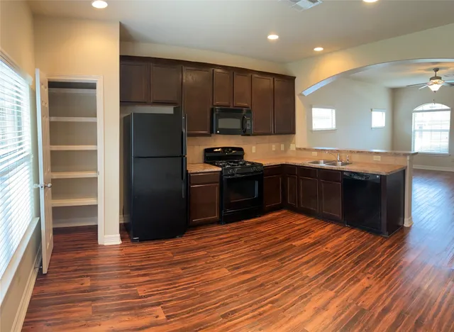a kitchen with stainless steel appliances granite countertop a stove and a refrigerator