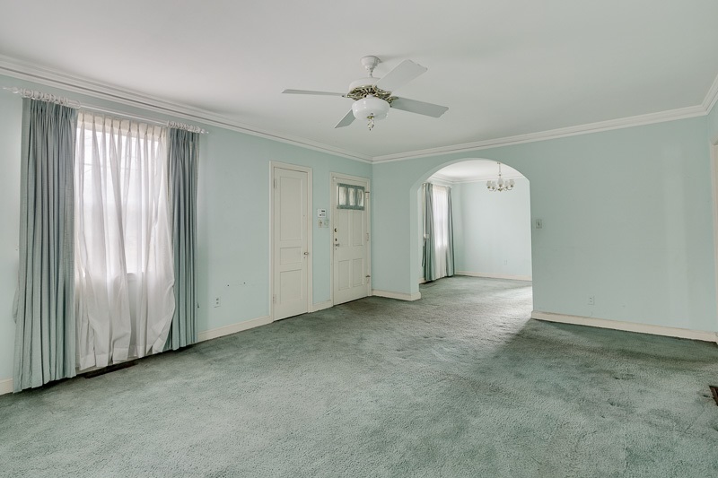 Hardwood floors under carpet! Dining room is through the archway.