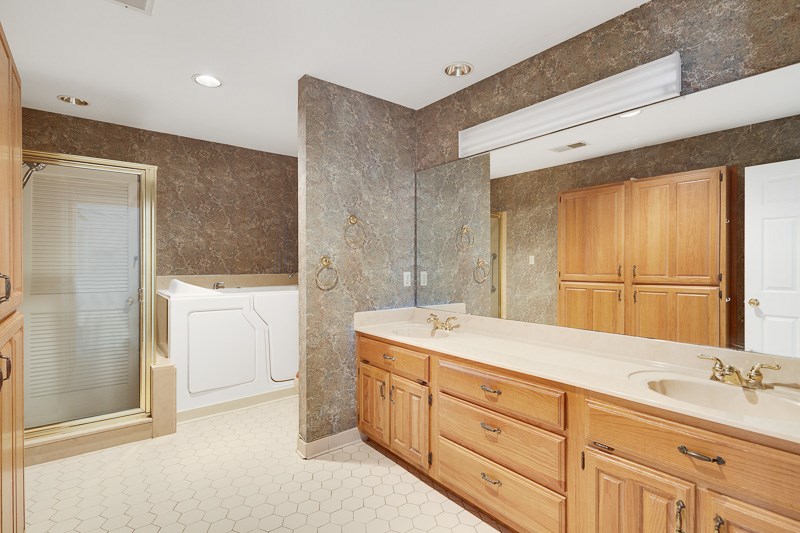 122 North Mendenhall Road Memphis, TN 38117 - Photo 12 of 24 Double sinks, separate shower and walk-in bath tub. It would be very easy to move the laundry to where the bathtub currently is!