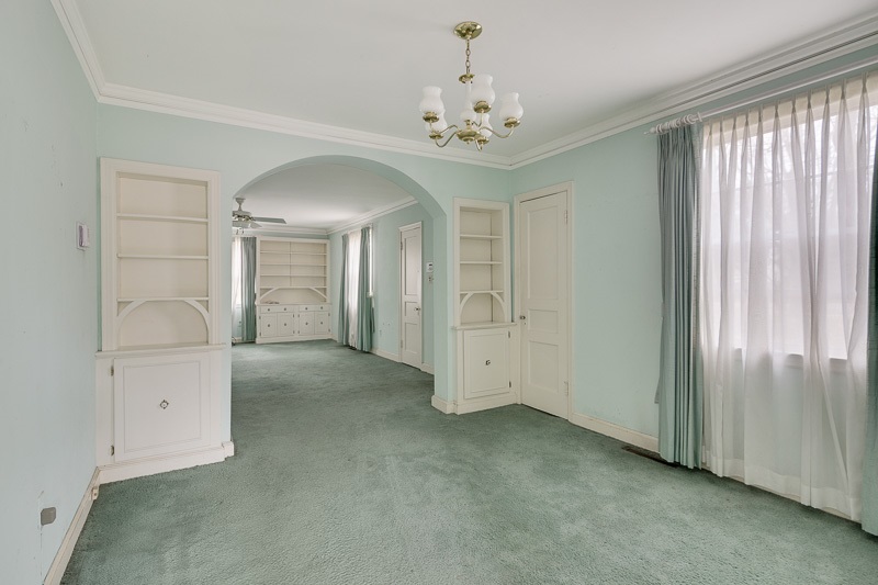 Dining room has a lot of charm: built-ins, a closet, and large archway.